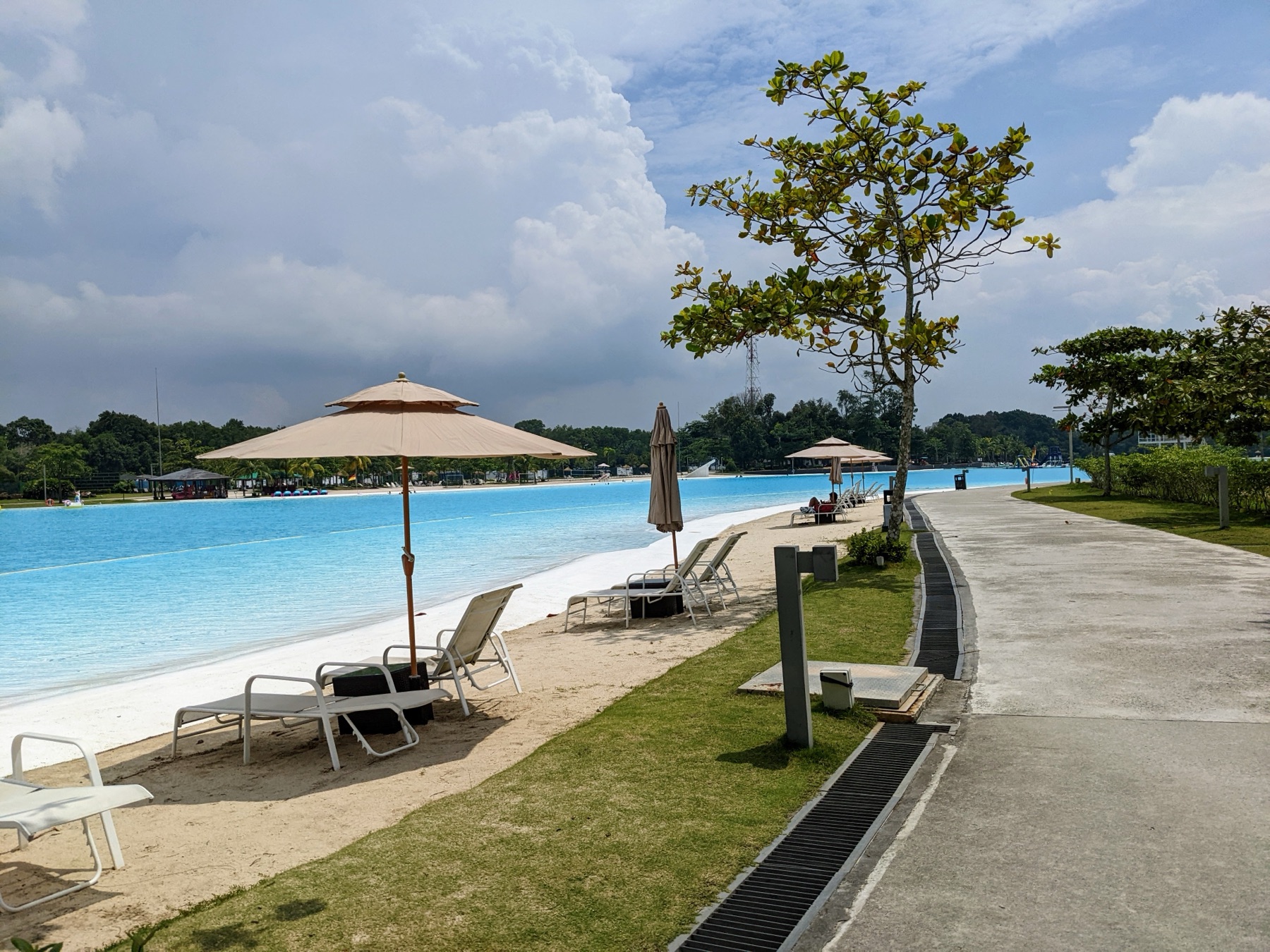 Turquoise water and sun loungers at the Crystal Lagoon, Treasure Bay Bintan — Southeast Asia’s largest man-made lagoon.