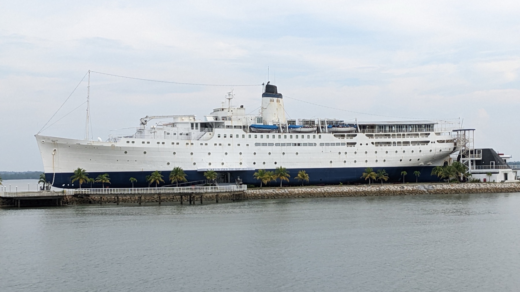 The white ocean liner Doulos Phos berthed on land as a hotel in Bintan.